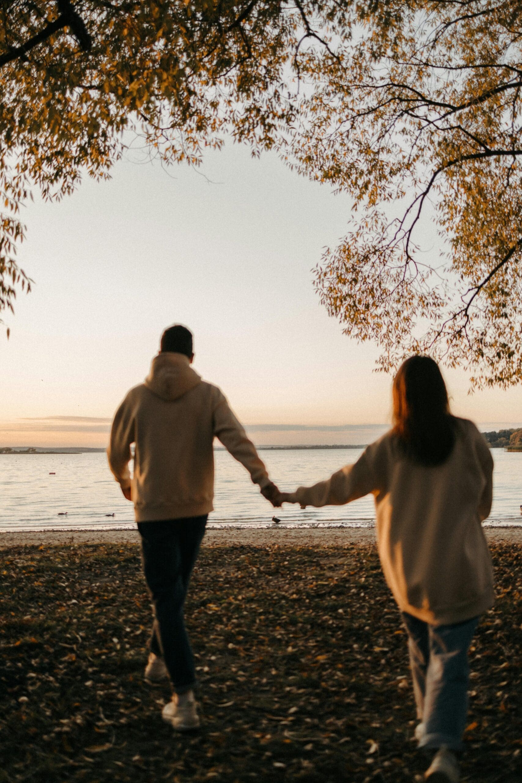 Couple walking together toward the water